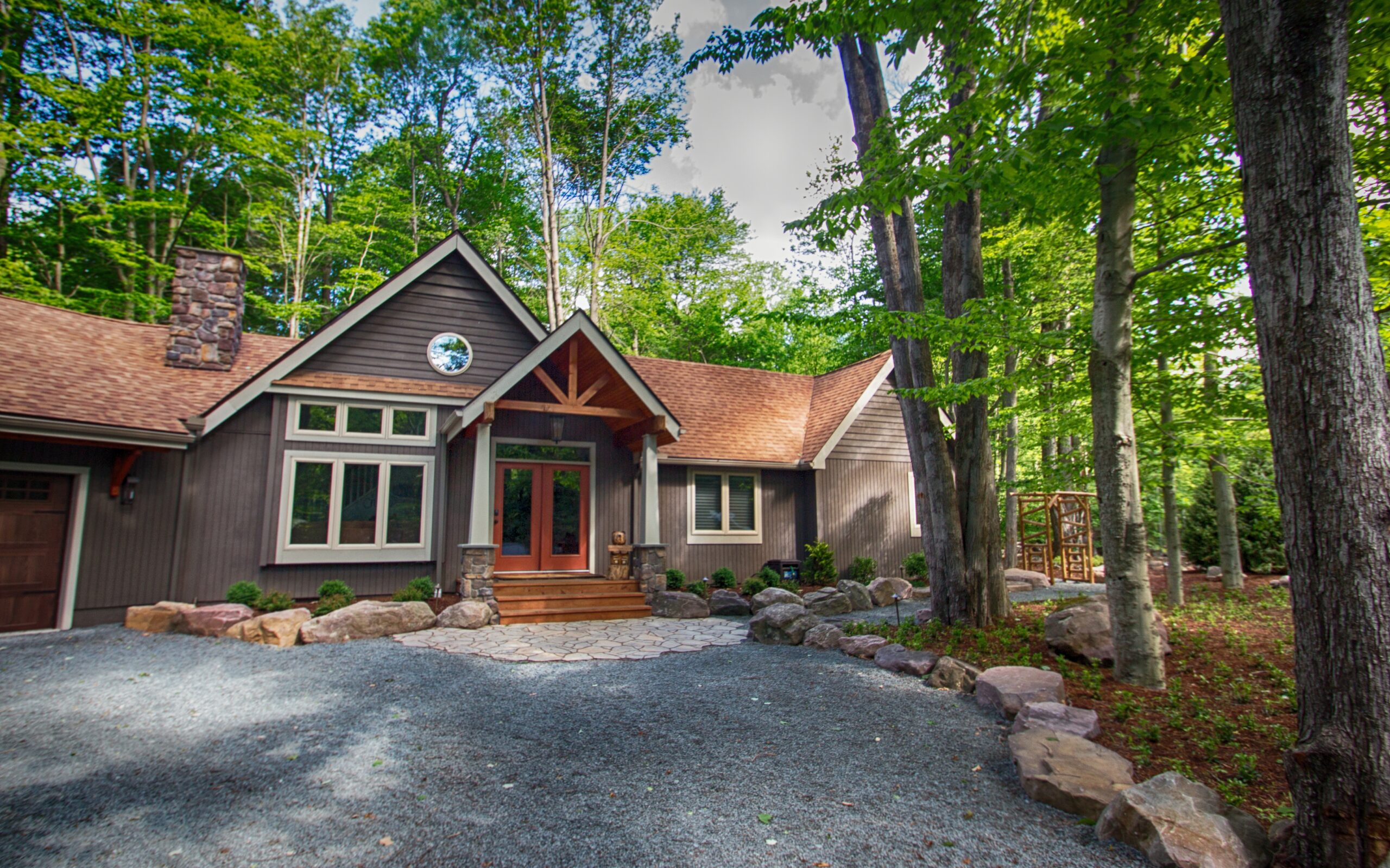 Completed landscape transformation by Erb's Landscaping with professional plantings, stone work, and manicured lawn