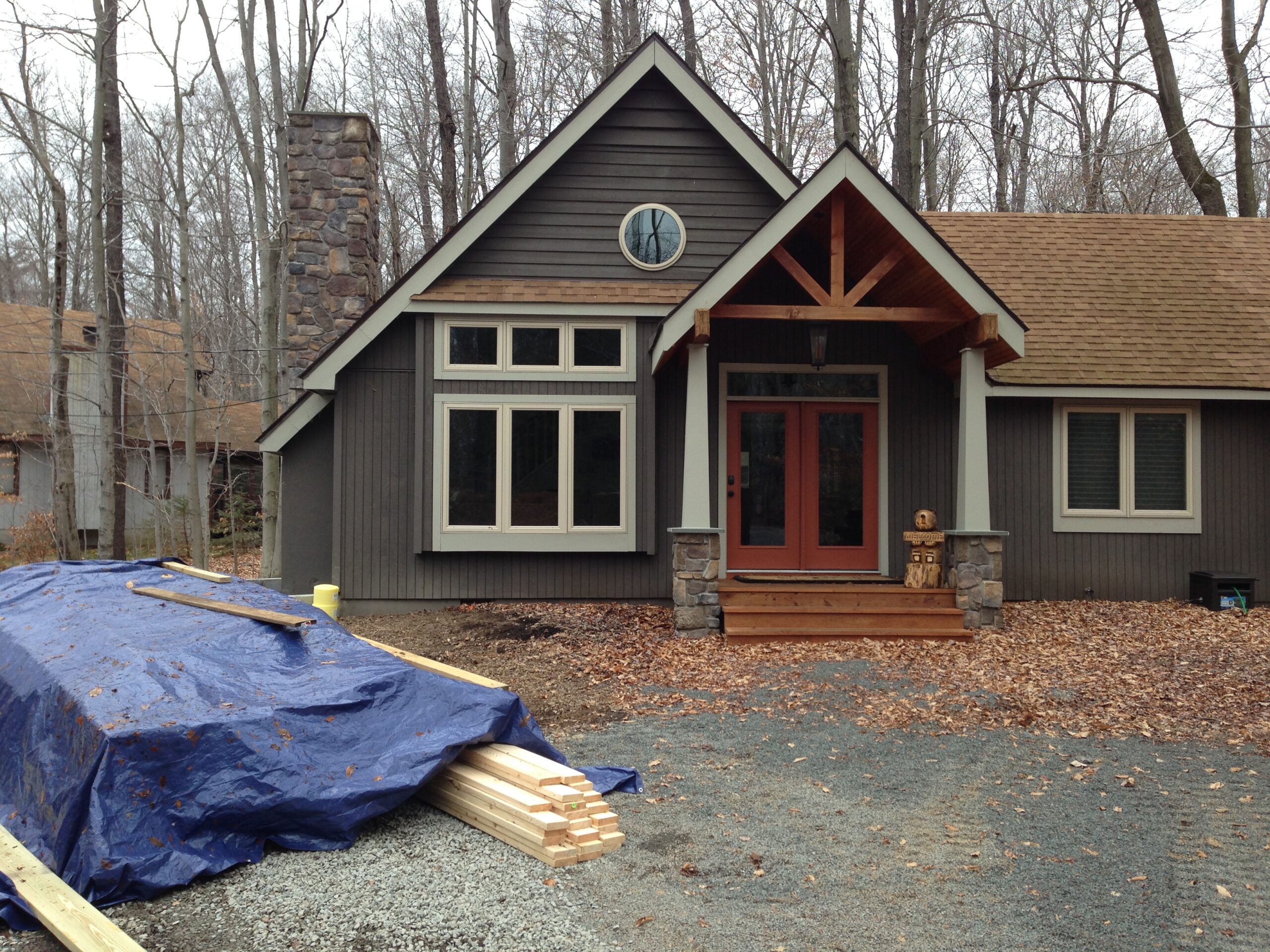 Yard before landscaping renovation by Erb's Landscaping showing bare terrain and overgrown areas