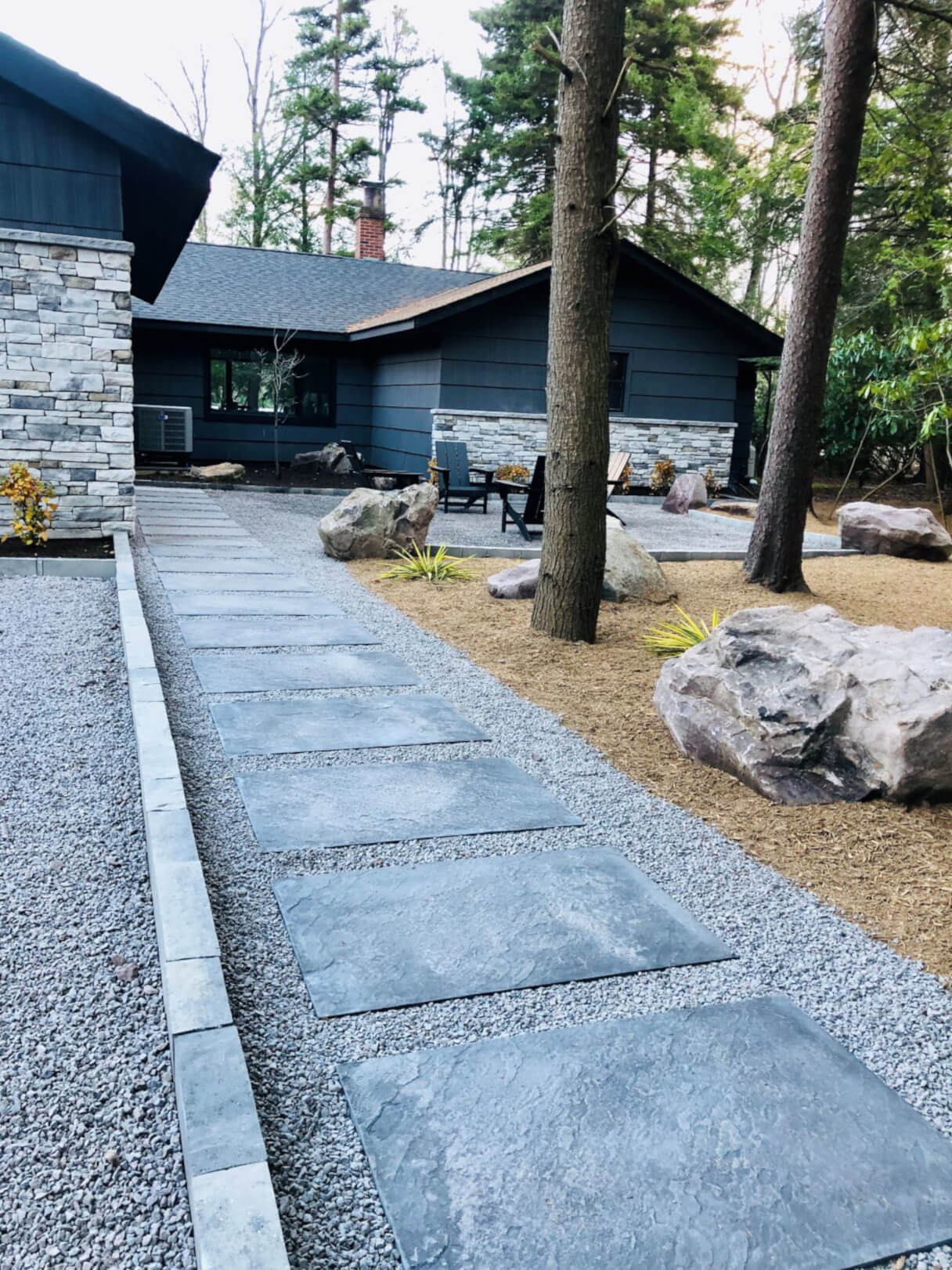 Paver walkway leading through landscaped front yard in the Pocono Mountains